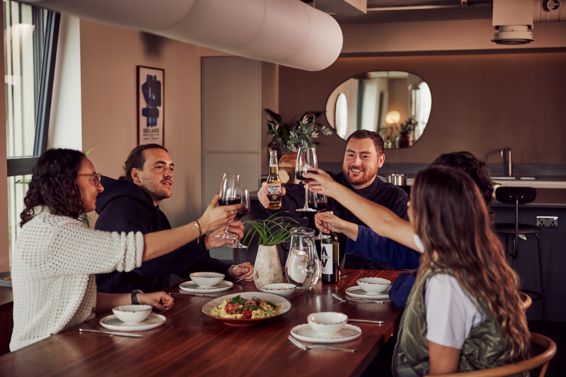Friends eating a meal a toasting.